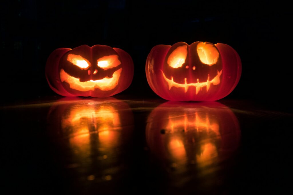 Two jack-o-lanterns lit up